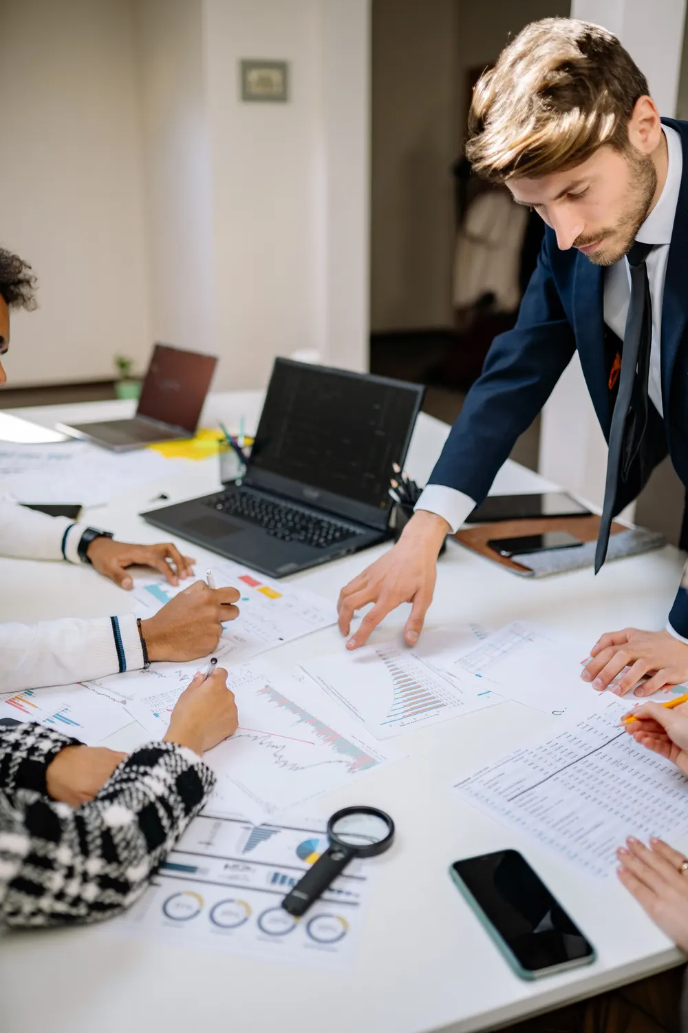 Advisers reviewing documents around a table